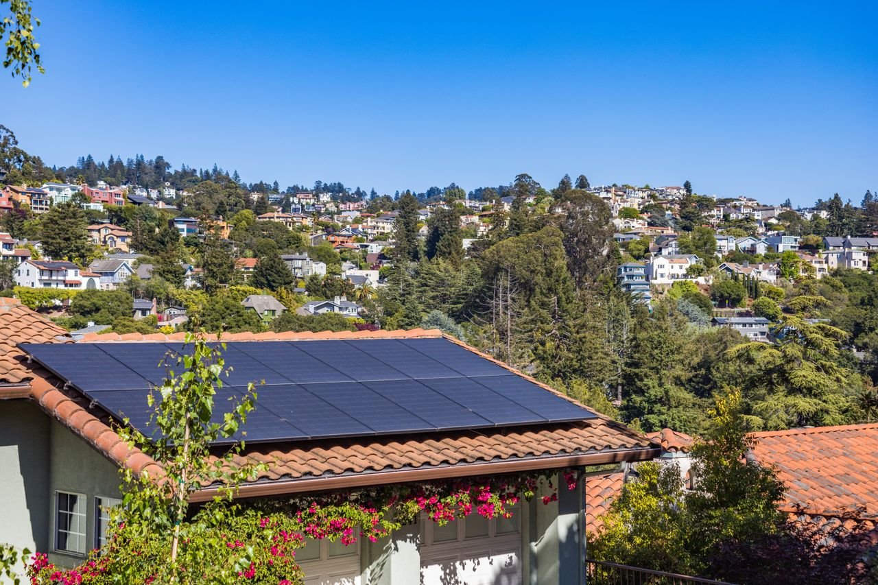Crafting Captivating Headlines: Your awesome post title goes here Solar panels on a suburban home, surrounded by lush greenery and a sunny blue sky.