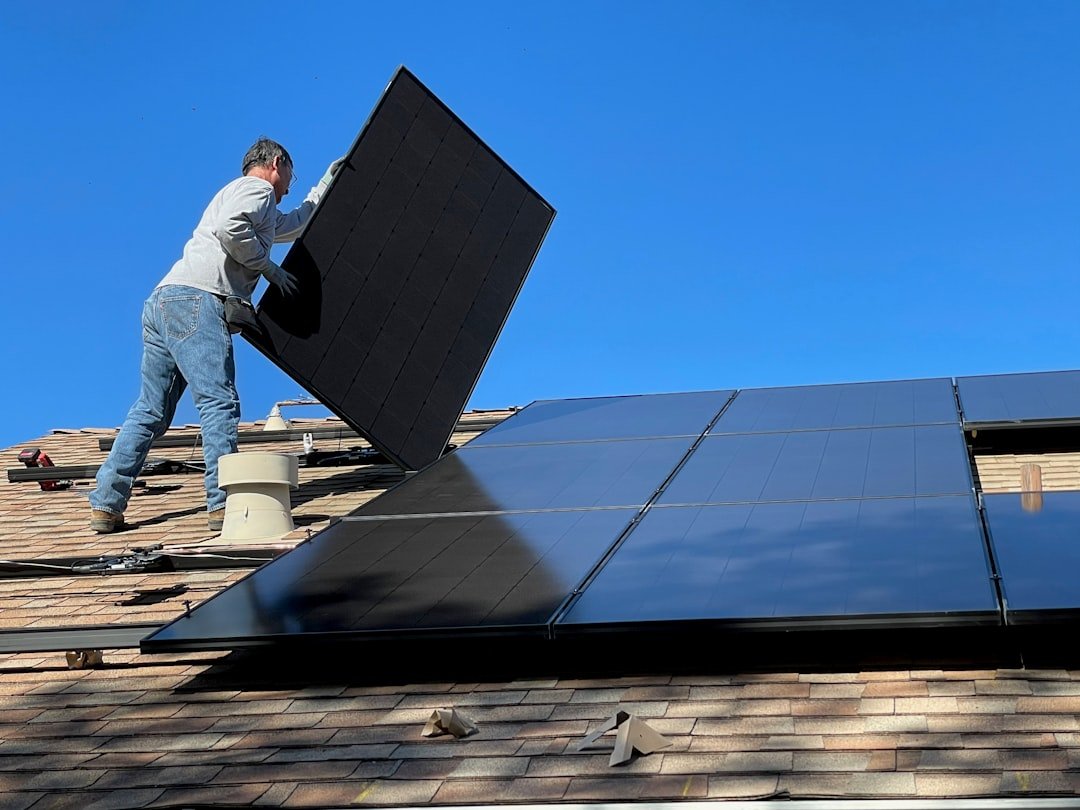 Services Worker installing solar panels on a roof